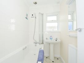 A bathroom with a bathtub sink and shower at Zapadiah in Polzeath