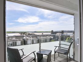 A balcony with chairs and a table overlooking the landscape at Slipway 15 Rock