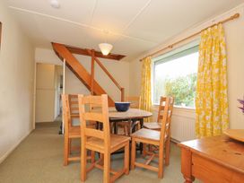 A dining room with a table and chairs at Avoca in Rock