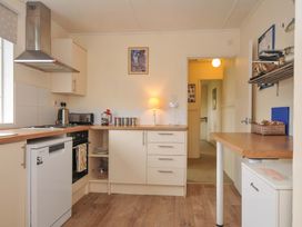 A kitchen with appliances and furniture at Avoca in Rock