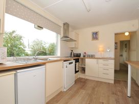 A kitchen with a sink, refrigerator, and stove at Avoca in Rock