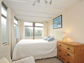A bedroom with a bed and window at Avoca in Rock