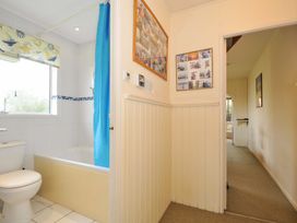 A bathroom with a shower, bathtub, and wall art at Avoca in Rock