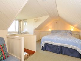 A bedroom with a bed and table at Avoca in Rock