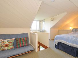 A bedroom with a sofa and a bed at Avoca in Rock