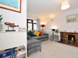 A living room with a sofa, fireplace, and decorative objects at Hazelhurst, Rock
