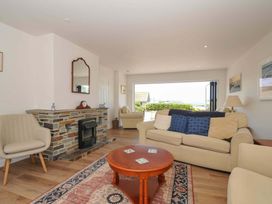 A living room with a sofa and coffee table at Sunset in Polzeath