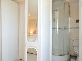 A bathroom with a shower and toilet at Sunset in Polzeath