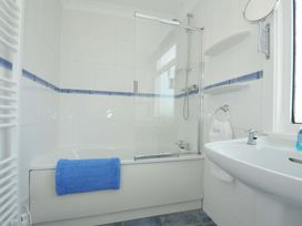 A bathroom with a bathtub and sink at Sunset in Polzeath