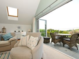 A living room with a sofa and armchair at Farlands in Daymer Bay