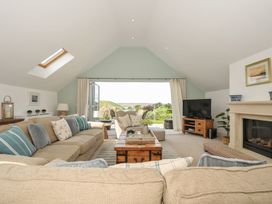 A living room with a sofa and coffee table at Farlands in Daymer Bay