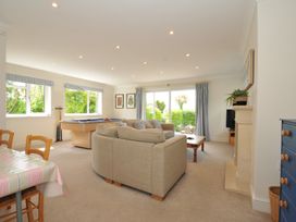 A living room with a sofa and pool table at Farlands in Daymer Bay