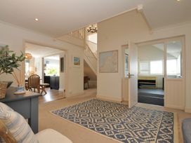 A living room with a rug and map at Farlands in Daymer Bay