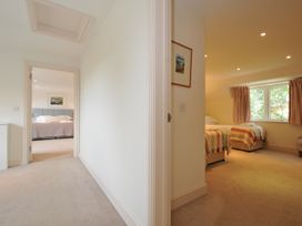 A hallway leading to a bedroom with two beds at Farlands Daymer Bay