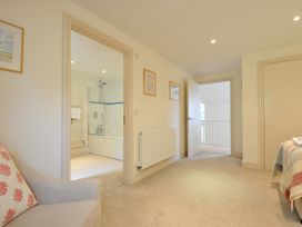 A hallway with sofa and bathroom entrance at Farlands in Daymer Bay