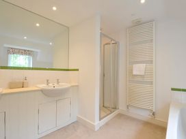 A bathroom with sinks and a shower at Farlands Daymer Bay