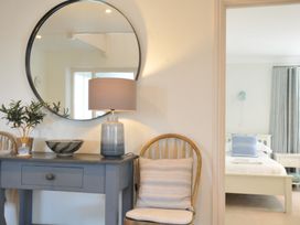A bedroom with a console table and lamp at Farlands in Daymer Bay