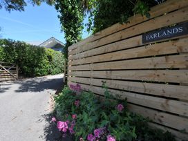 An entrance with a wooden gate and pathway at Farlands in Daymer Bay