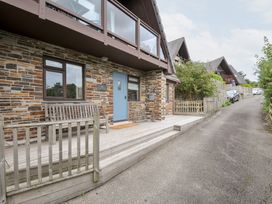An outdoor view of a house with a blue door and a wooden bench at Rocklings in Rock