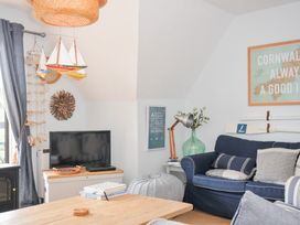 A living room with a television and a sofa at Rocklings in Rock