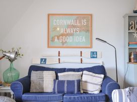 A living room with a blue sofa and wall decoration at Rocklings in Rock