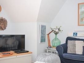 A living room with a television and a sofa at Rocklings in Rock