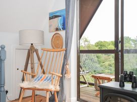 A living room with a rocking chair and a balcony view at Rocklings in Rock