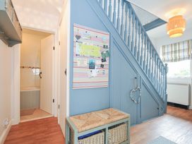 A hallway with a staircase and storage bench at Rocklings in Rock