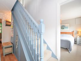 A staircase leading to a bedroom with a door and seating at Rocklings Rock
