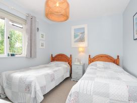 A bedroom with two single beds and a bedside table at Rocklings in Rock