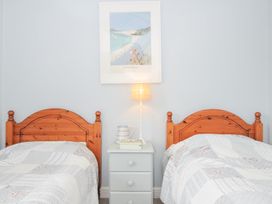 A bedroom with two beds and a bedside table at Rocklings in Rock