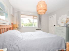 A bedroom with a wooden bed and window at Rocklings in Rock