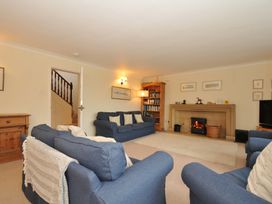 A living room with sofas and a fireplace at Tregillan in Rock
