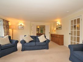 A living room with sofas and a sideboard at Tregillan in Rock