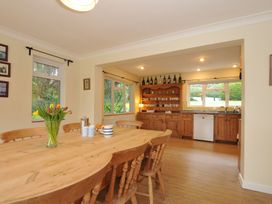 A kitchen with a large wooden table and chairs at Tregillan in Rock