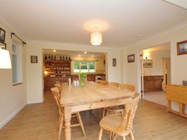 A dining room with a wooden table and chairs at Tregillan in Rock