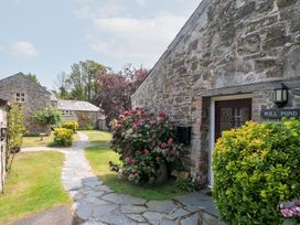 An outdoor area with stone buildings and a pathway at Mill Pond in Rock