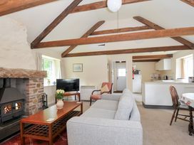 A living room with a fireplace and a television at Mill Pond in Rock