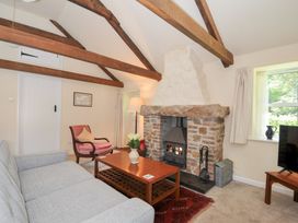 A living room with a fireplace and sofa at Mill Pond in Rock