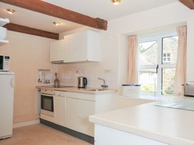 A kitchen with appliances and a window at Mill Pond in Rock