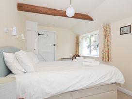 A bedroom with a bed and window at Mill Pond in Rock