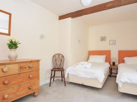 A bedroom with twin beds and a wooden dresser at Mill Pond in Rock
