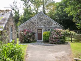 A house with a stone exterior and garden at Mill Pond in Rock