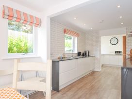 A kitchen with windows and appliances at Porthilly Brook in Rock