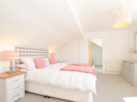 A bedroom with a bed and lamps at Porthilly Brook in Rock