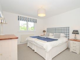 A bedroom with a bed and lamps at Porthilly Brook in Rock