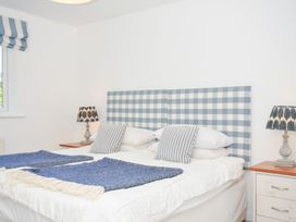A bedroom with a bed and bedside lamps at Porthilly Brook in Rock