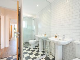 A bathroom with sinks and a shower at Porthilly Brook Rock