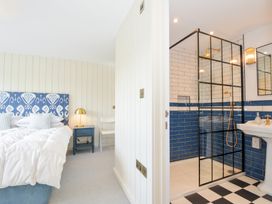 A bedroom with a bed and attached shower area at Porthilly Brook in Rock
