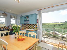 A kitchen with a table and chairs at Cartway Cove in Port Isaac